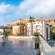 The modern outdoor terrace of the Acropolis Museum with stone flooring and seating overlooking the ancient Acropolis